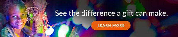 See the difference a gift can make. Learn more. A child smiles while holding on to one of many differently colored light bulbs.